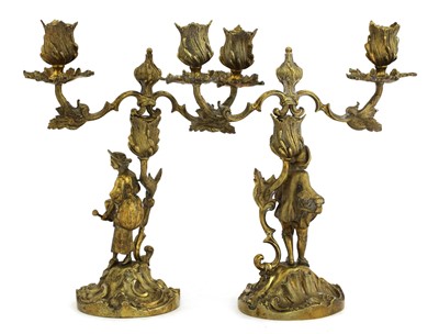 Lot 5 - A pair of Elizabeth II silver gilt figural candelabra