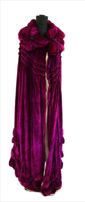 Lot 1088 - A theatrical fuchsia pink velvet cape