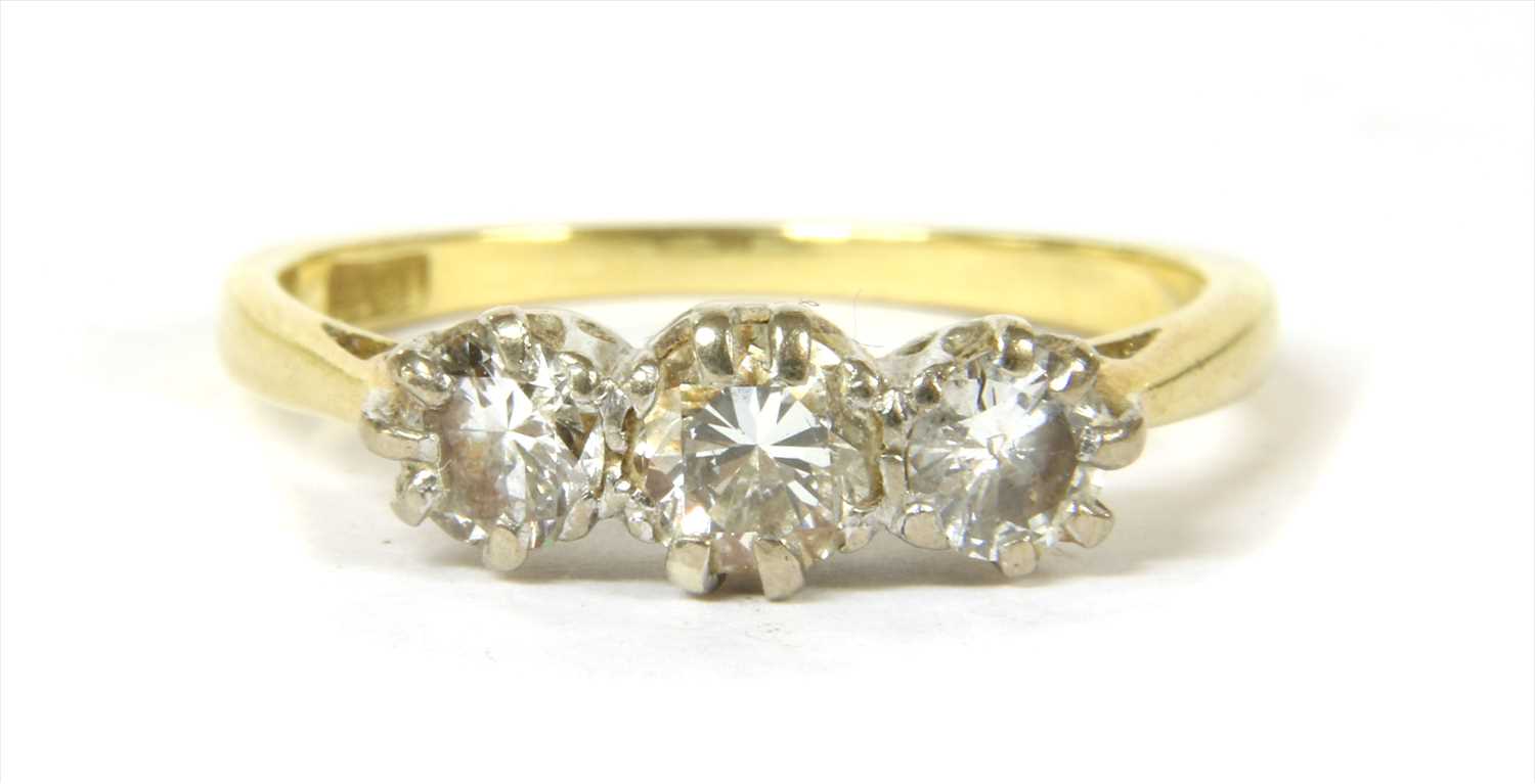 Lot 80 - A gold three stone diamond ring