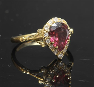 Lot 224 - An 18ct gold garnet and diamond pear-shaped cluster ring
