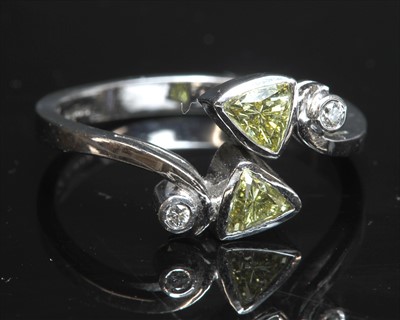Lot 271 - An 18ct white gold four stone diamond crossover ring