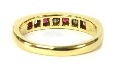 Lot 131 - An 18ct gold diamond and pink sapphire half eternity ring
