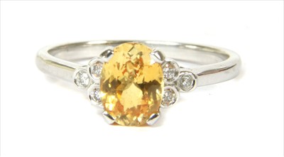 Lot 134 - An 18ct gold yellow sapphire and diamond ring
