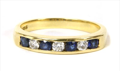 Lot 62 - An 18ct gold diamond and sapphire half eternity ring