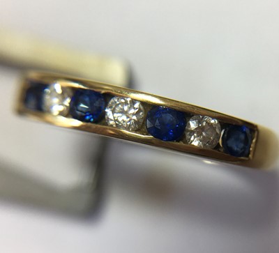 Lot 62 - An 18ct gold diamond and sapphire half eternity ring