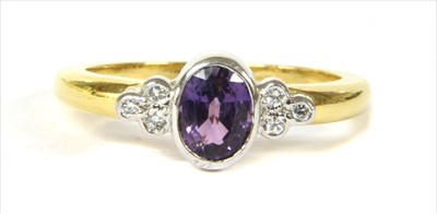 Lot 135 - An 18ct gold purple sapphire and diamond ring