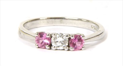 Lot 132 - An 18ct white gold three stone diamond and pink sapphire ring