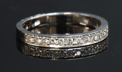 Lot 310 - An 18ct white gold diamond set half eternity ring