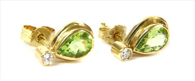 Lot 94 - A pair of 18ct gold peridot and diamond earrings
