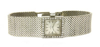 Lot 37 - A ladies' 18ct white gold diamond set Omega mechanical bracelet watch, c.1960