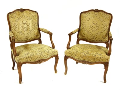 Lot 665 - A pair of early 20th century French style open elbow chairs