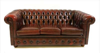 Lot 470 - A red leather Chesterfield three seater sofa