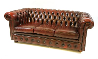 Lot 469 - A red leather Chesterfield three seater sofa