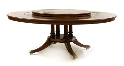 Lot 657 - A George III style mahogany and crossbanded circular extending dining table