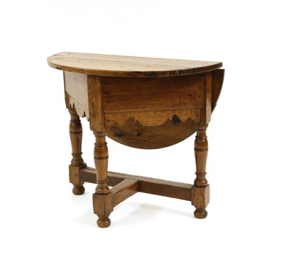 Lot 330 - A small 17th century style oak drop leaf table