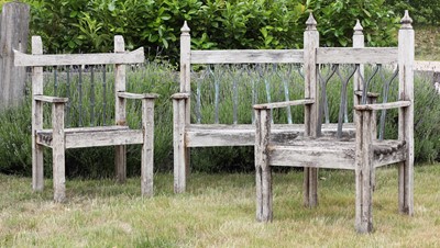 Lot 299 - A weathered Gothic design teak garden bench