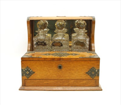 Lot 377 - A Victorian oak and silver plated Tantalus