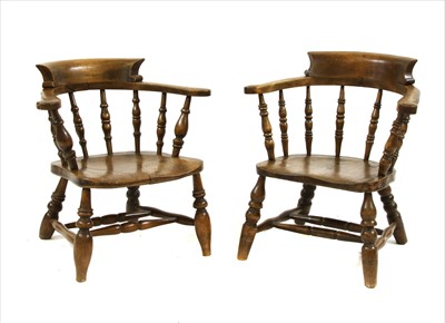 Lot 456 - A pair of oak low spindle back elbow chairs