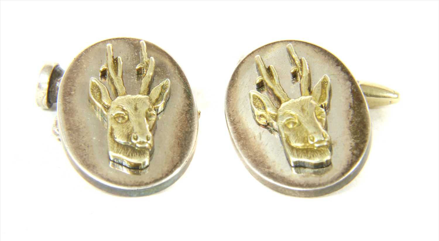 Lot 33 - A pair of silver gilt stag cufflinks, by Holland & Holland