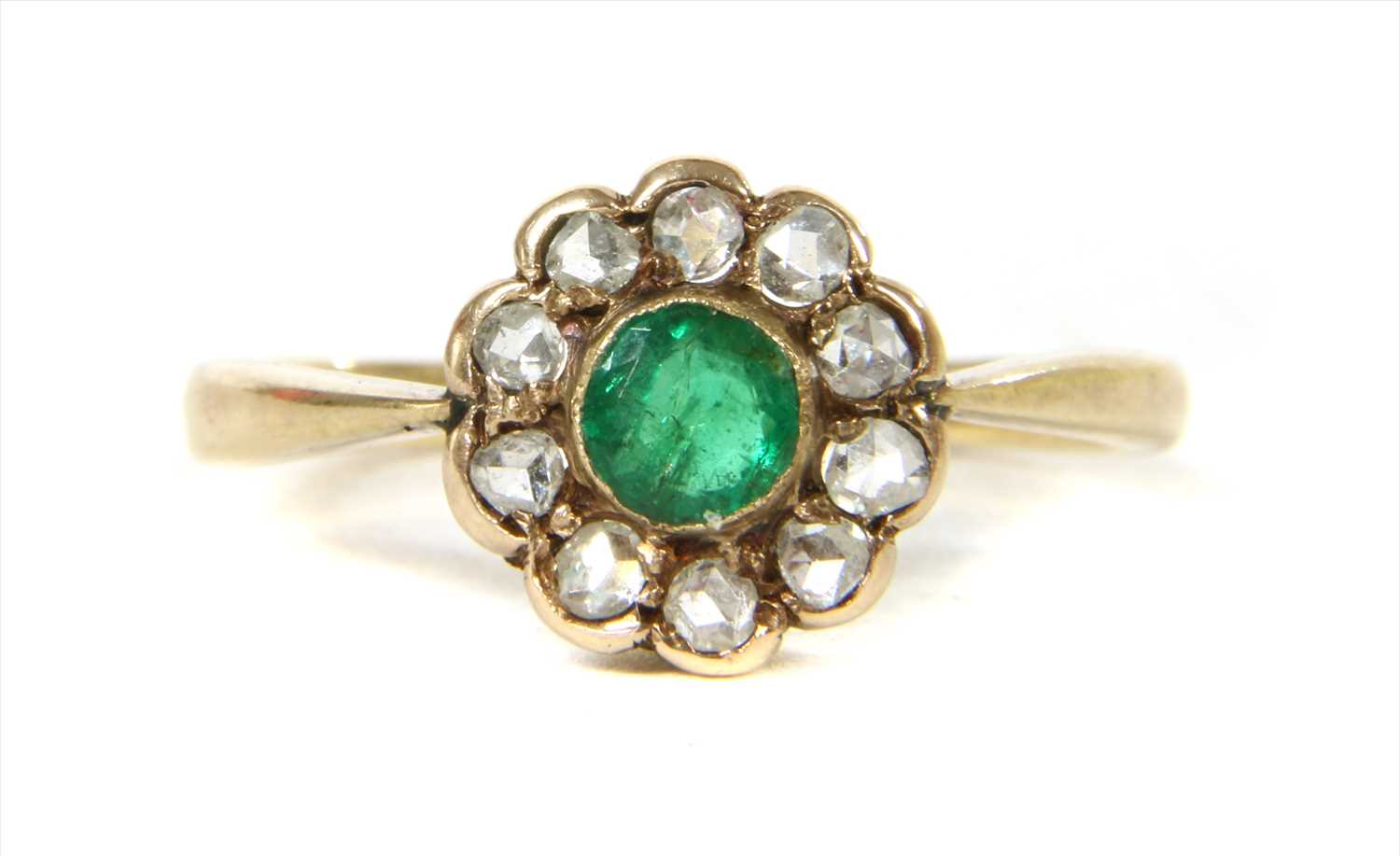 Lot 10 - A gold emerald and diamond cluster ring