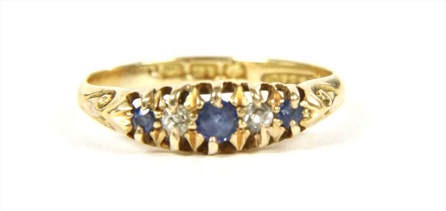 Lot 22 - An 18ct gold boat shaped sapphire and diamond ring