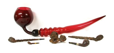 Lot 154 - A collection of four carved treen pipes