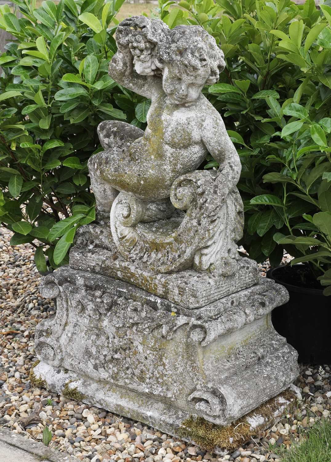 Lot 293 - A reconstituted stone cherub
