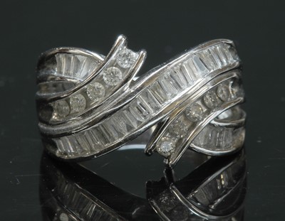 Lot 303 - An American white gold three row diamond set crossover band ring