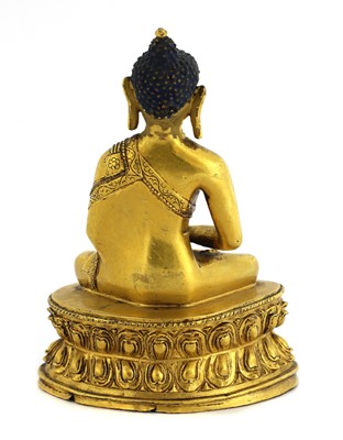 Lot 63 - A Tibetan gilt bronze Shakyamuni Buddha