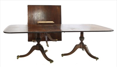 Lot 516 - A Georgian style triple pillar mahogany dining table