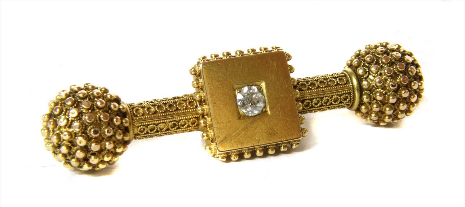 Lot 85 - A Victorian Etruscan revival gold diamond dumb-bell bar brooch, c.1870