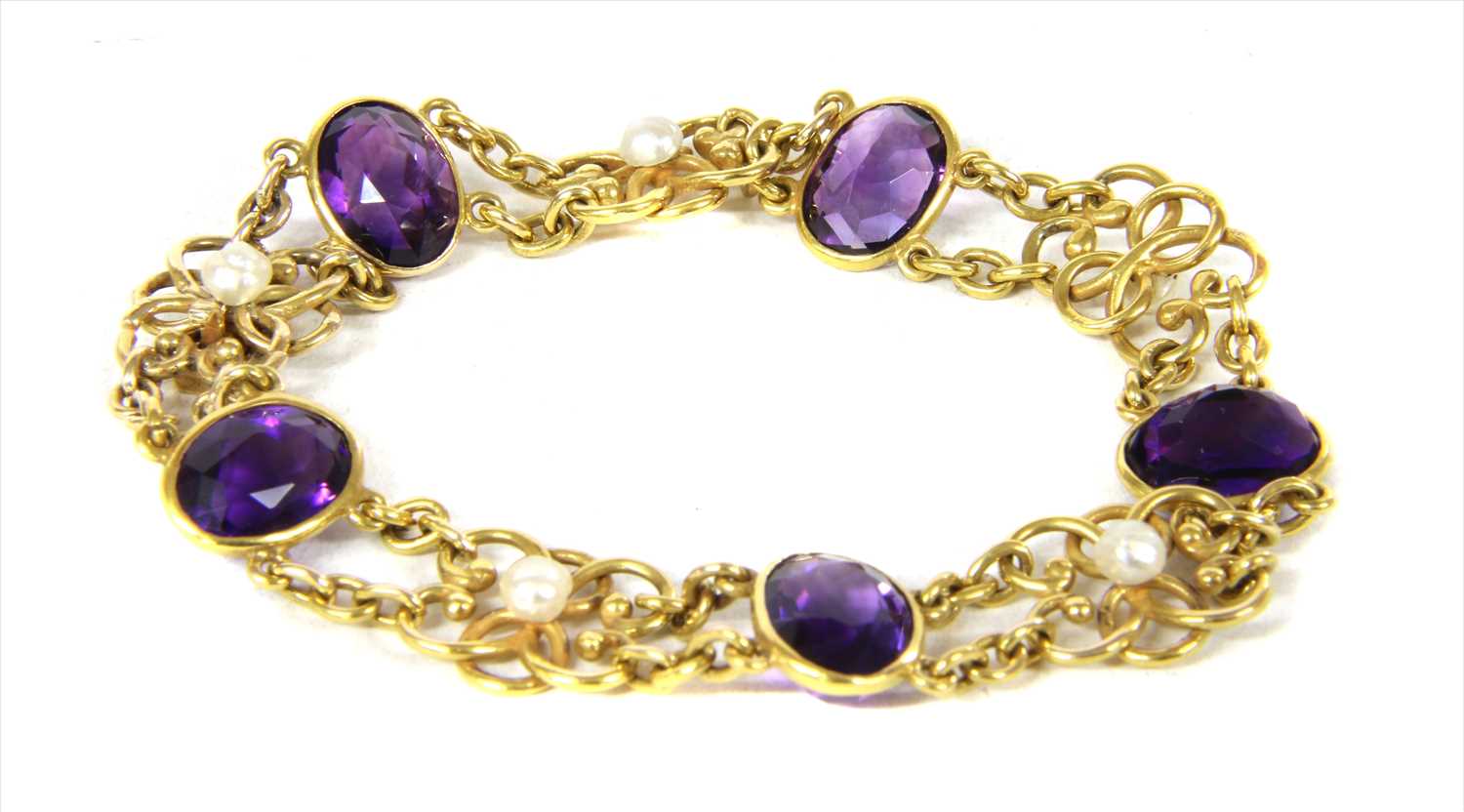 Lot 31 - An Edwardian gold amethyst and pearl bracelet