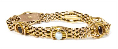 Lot 35 - A gold garnet and blister pearl gate bracelet