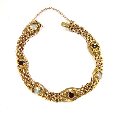 Lot 35 - A gold garnet and blister pearl gate bracelet