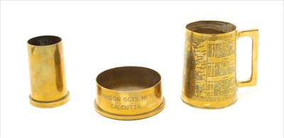 Lot 235 - Two brass shell case items and mug