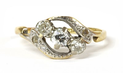 Lot 158 - A gold three stone diamond crossover ring