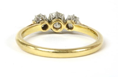 Lot 157 - A gold and platinum three stone diamond ring