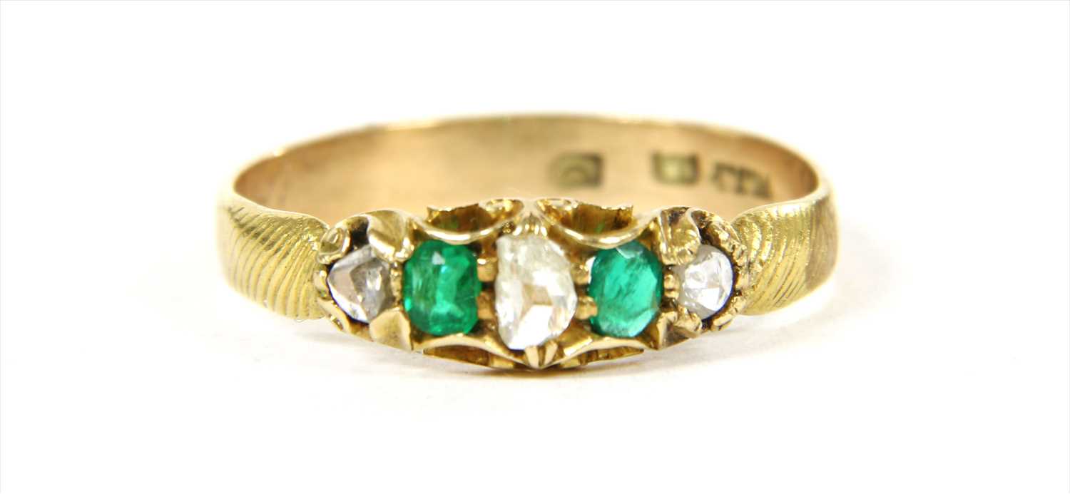 Lot 15 - A gold five stone diamond and emerald ring