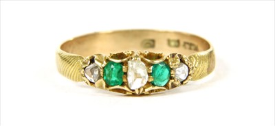 Lot 15 - A gold five stone diamond and emerald ring