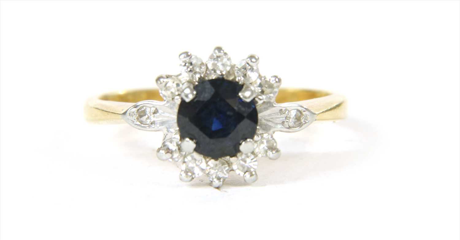 Lot 52 - An 18ct gold sapphire and diamond cluster ring