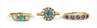 Lot 39 - A gold three stone blue zircon and diamond ring