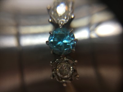 Lot 39 - A gold three stone blue zircon and diamond ring