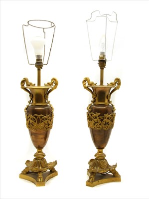 Lot 283 - A pair of bronze urn form table lamps having gilt mounts, (2)