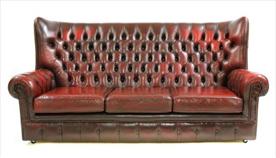 Lot 422 - A red leather wingback sofa