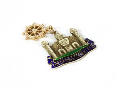 Lot 13 - A white gold enamel Cambridgeshire Regiment military sweetheart pendant