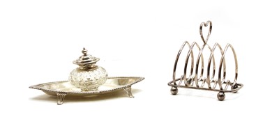 Lot 6 - An oval silver ink stand with cut glass well