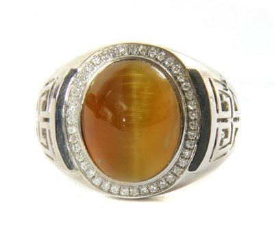 Lot 139 - A white gold tiger's eye and diamond ring