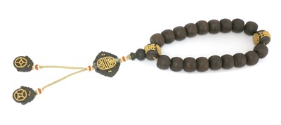 Lot 221 - A Chinese wooden bead rosary