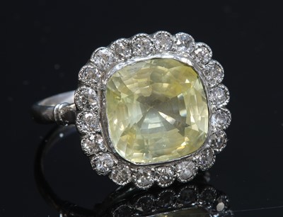 Lot 246 - A yellow sapphire and diamond cushion-shaped cluster ring