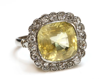 Lot 246 - A yellow sapphire and diamond cushion-shaped cluster ring